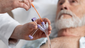 Patient getting their feeding tube unclogged with DeClogger by clinician.