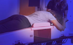 Prone breast unit in use with patient and therapist.